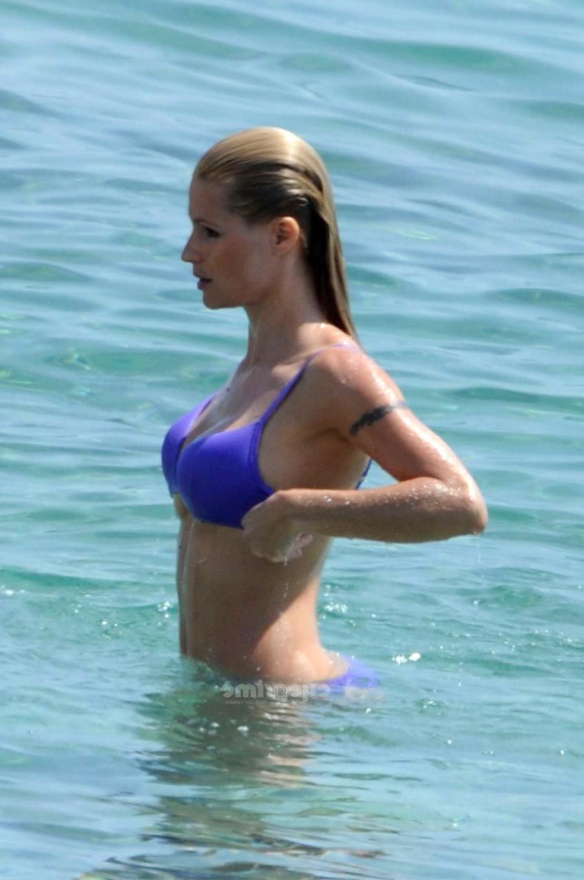 16P Michelle Hunziker looking very sexy in blue bikini on beach paparazzi pictures