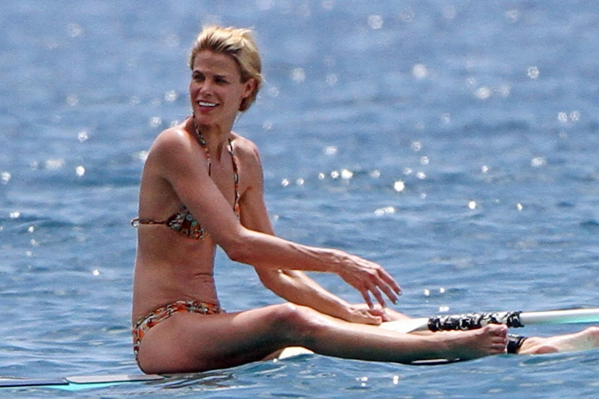 16P Brooke Burns in bikini paddle surfing on a Hawaiian beach