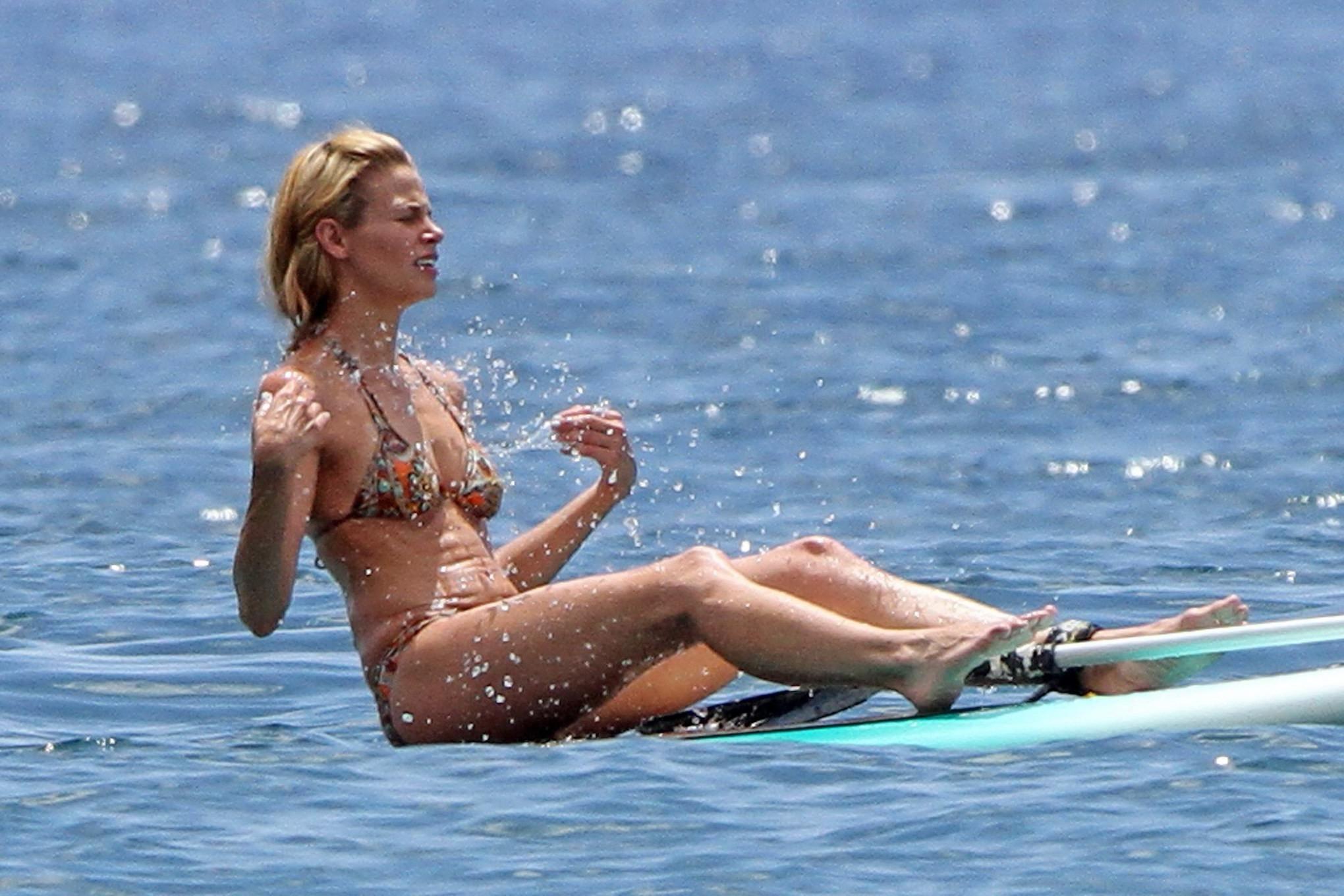 16P Brooke Burns in bikini paddle surfing on a Hawaiian beach