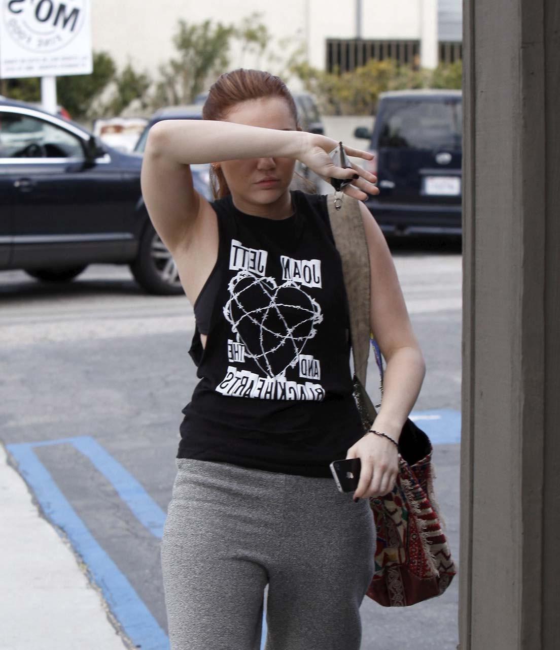 16P Miley Cyrus looking very drunk and showing tattoo under her tits