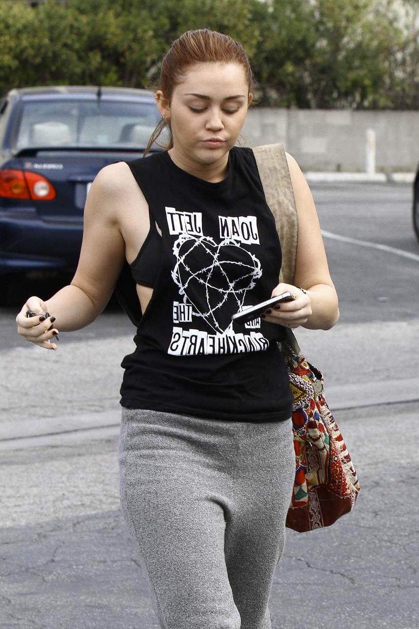 16P Miley Cyrus looking very drunk and showing tattoo under her tits