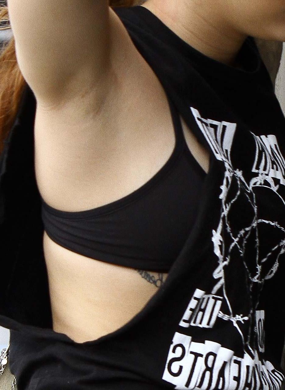 16P Miley Cyrus looking very drunk and showing tattoo under her tits