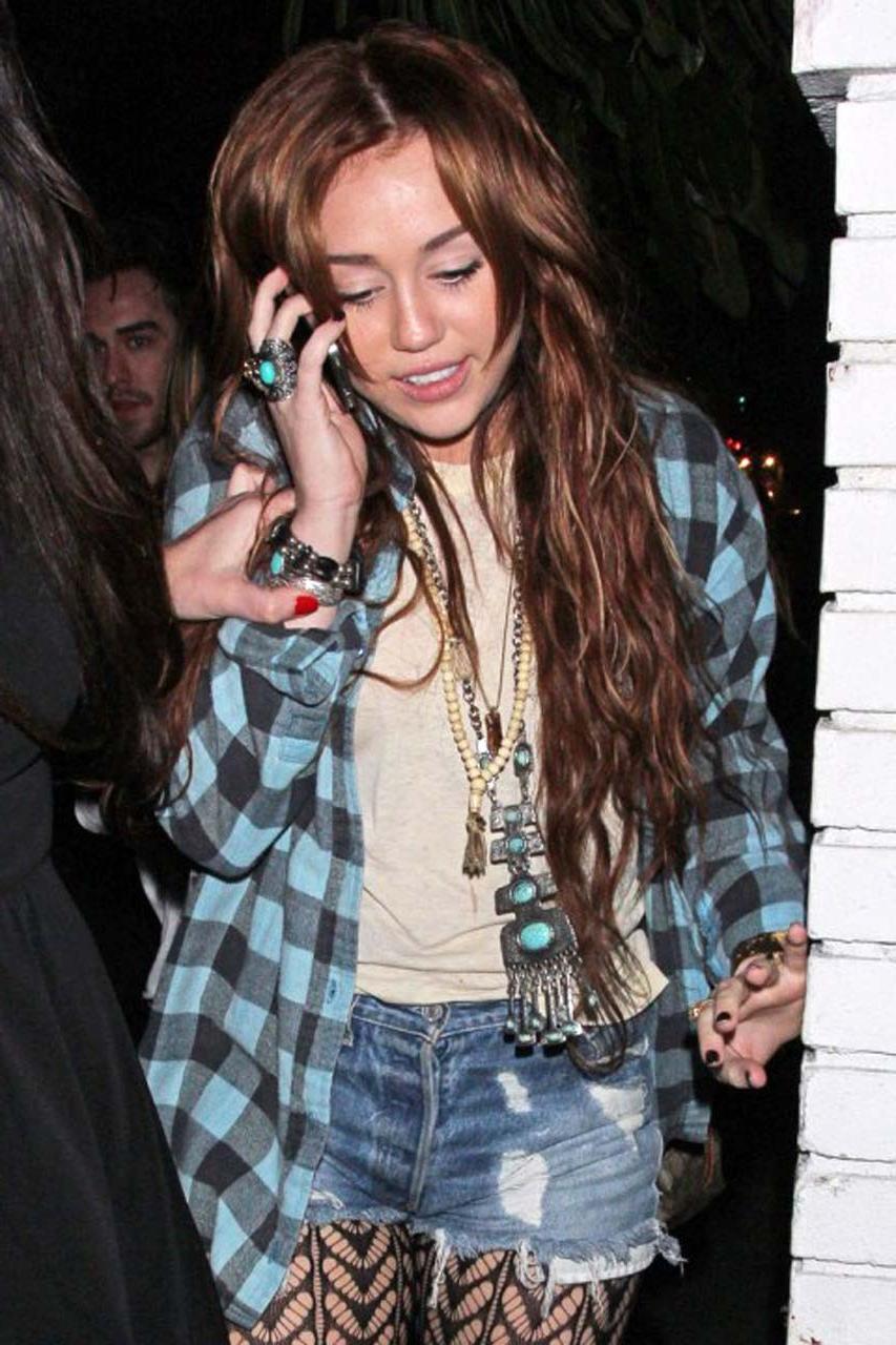 16P Miley Cyrus looking very drunk and showing tattoo under her tits