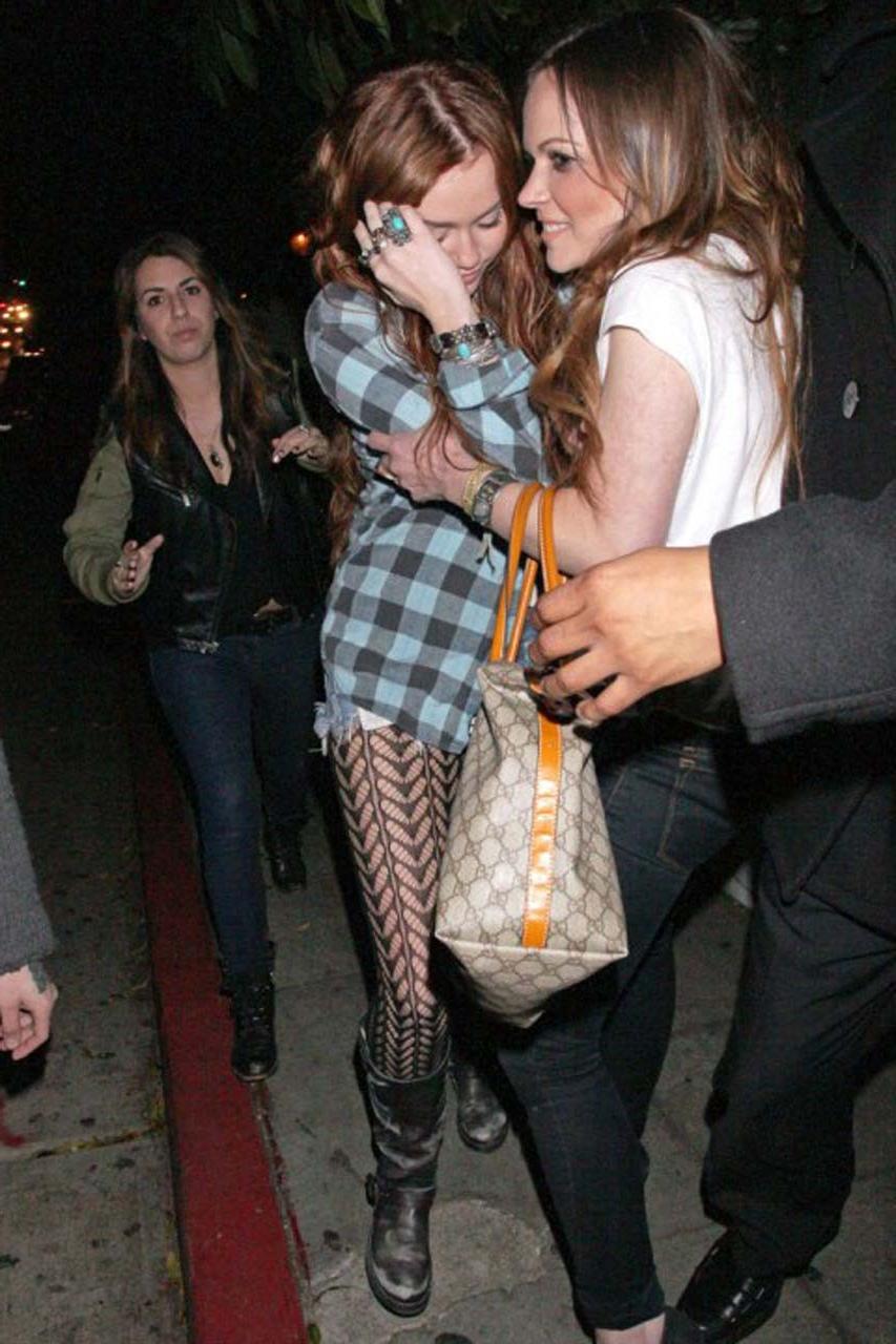 16P Miley Cyrus looking very drunk and showing tattoo under her tits