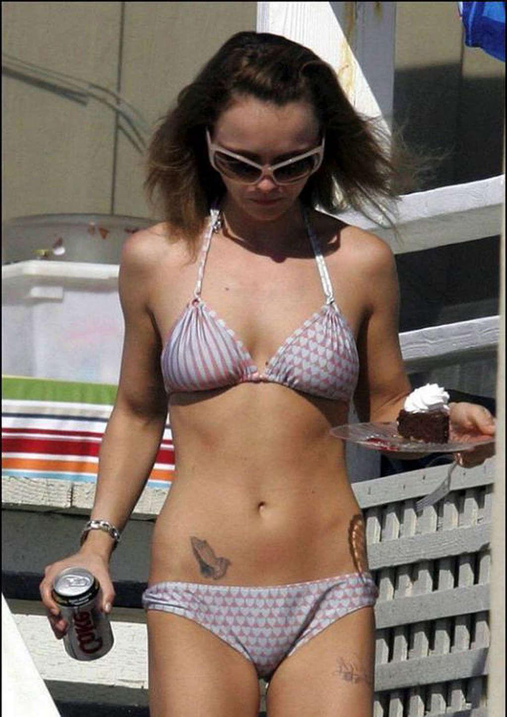 16P Christina Ricci looking very drunk in bikini with a beer in a hand