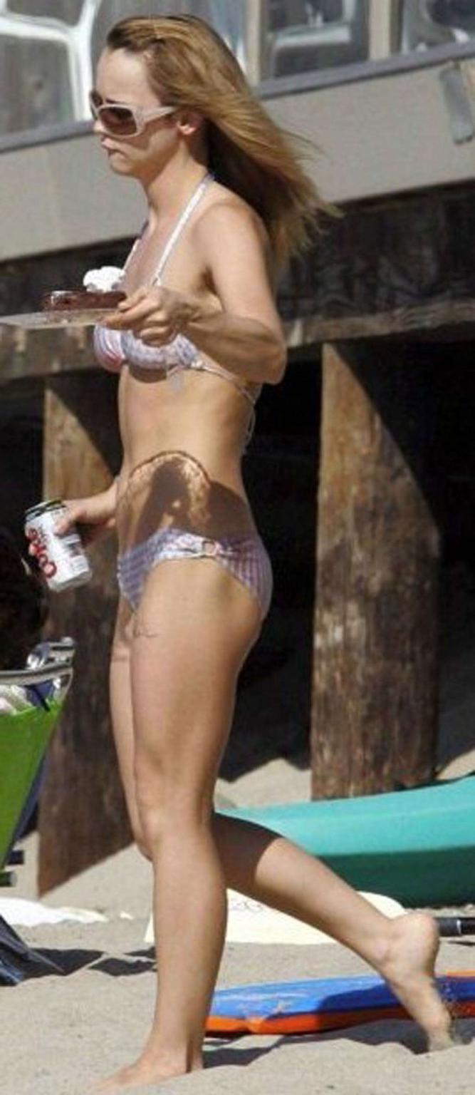 16P Christina Ricci looking very drunk in bikini with a beer in a hand