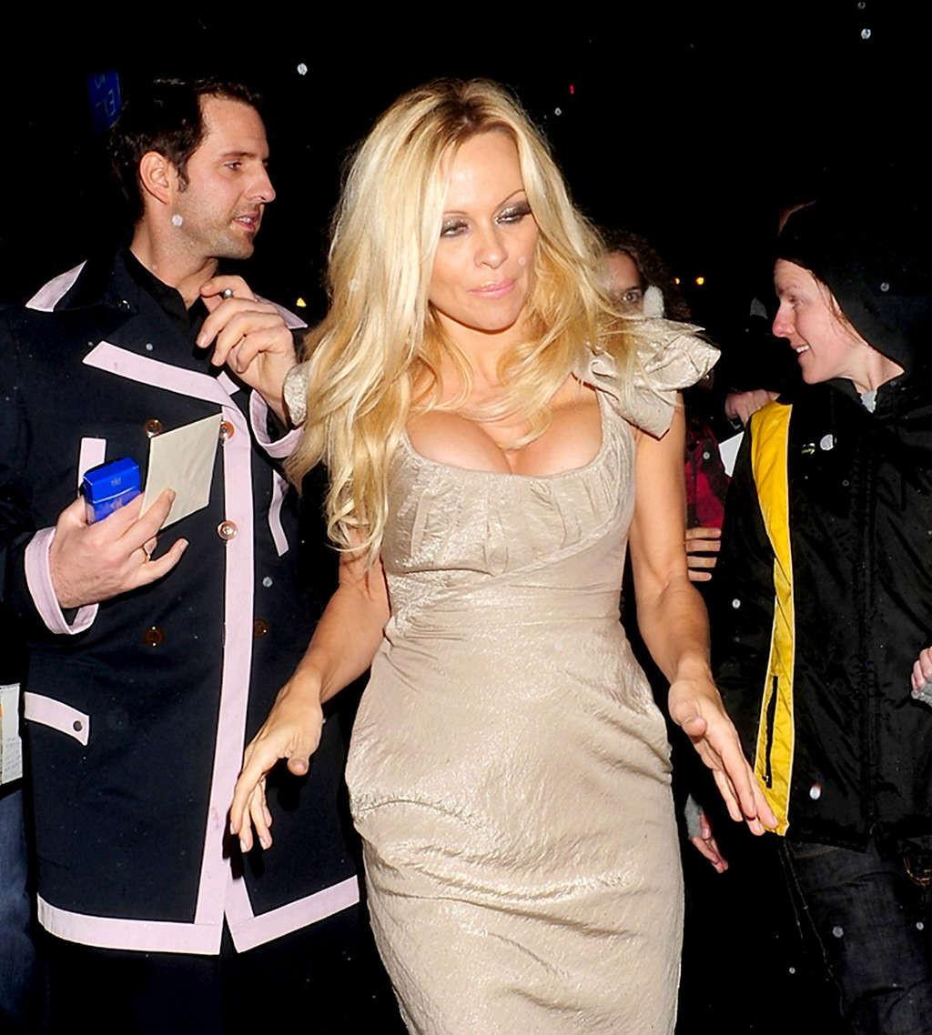 10P Pamela Anderson very busty in skimpy swimsuit and exposing her nice tits and ups