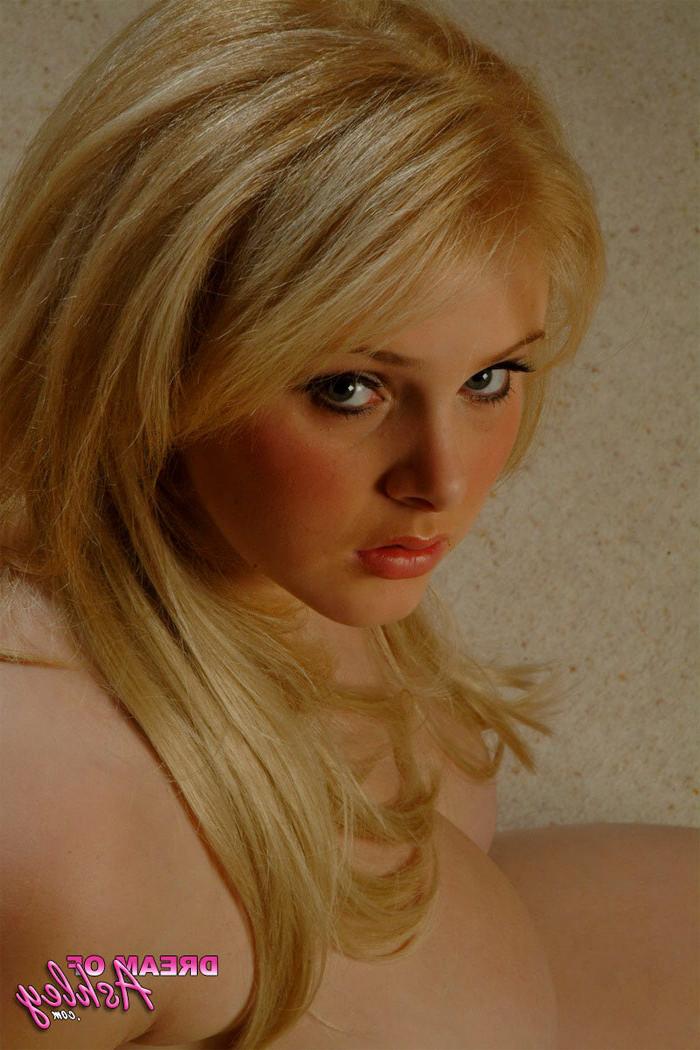 15P Busty blonde squeezes her big tits into pink corset