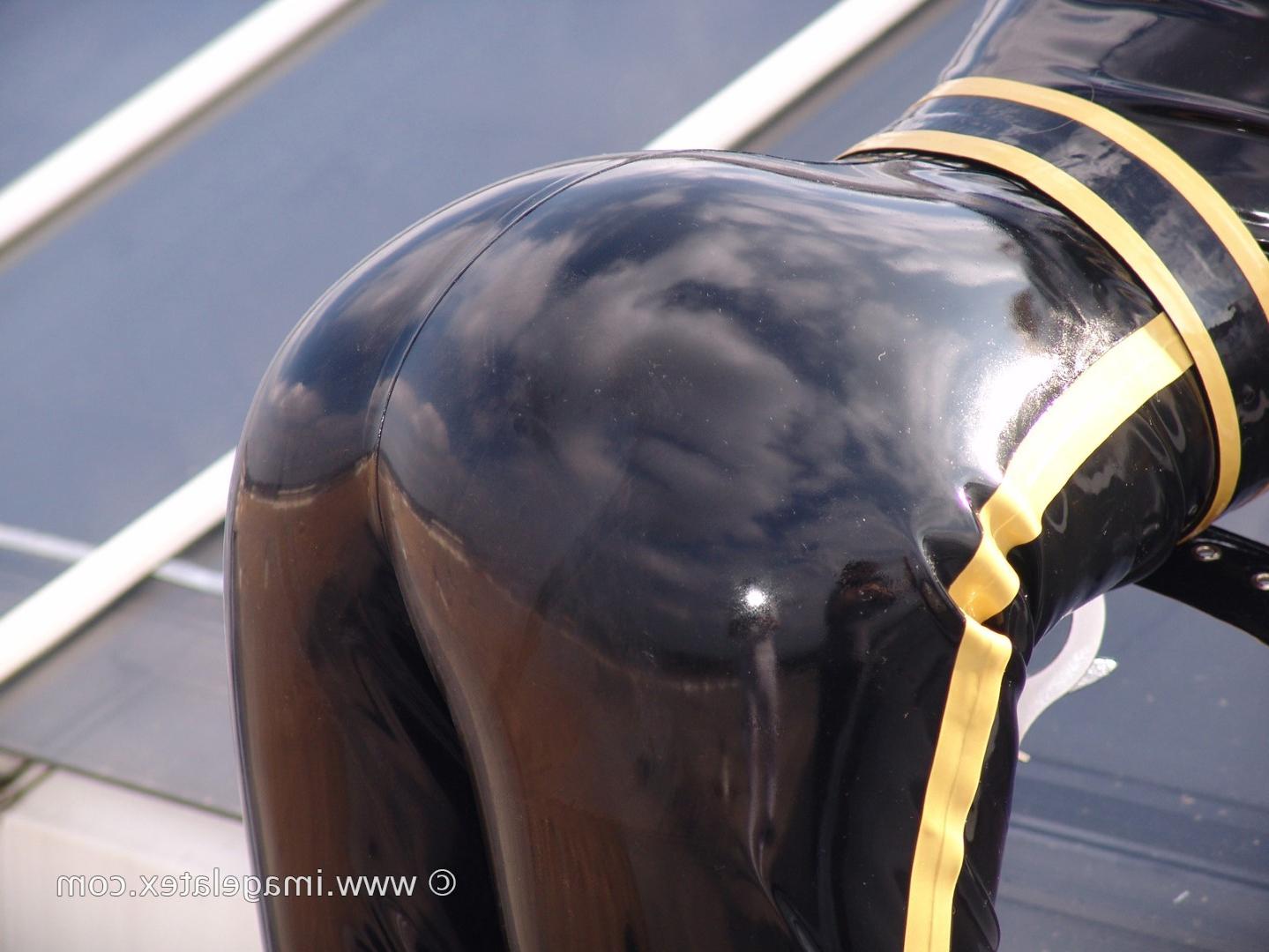 16P Pretty blonde Natalie poses up on the roof in a latex police cat