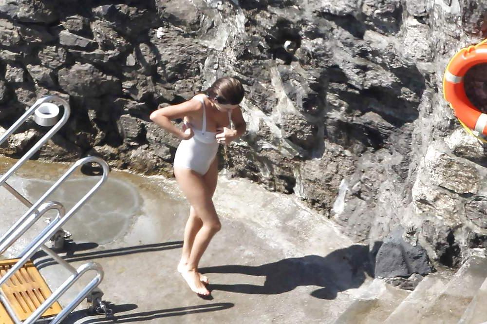 14P Penelope Cruz relaxing by the pool in a swimsuit
