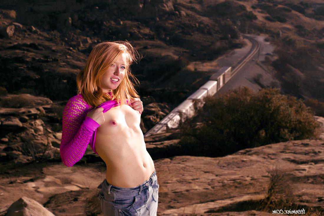 20P Freckled redhead beauty shows off her sexy round ass outdoors