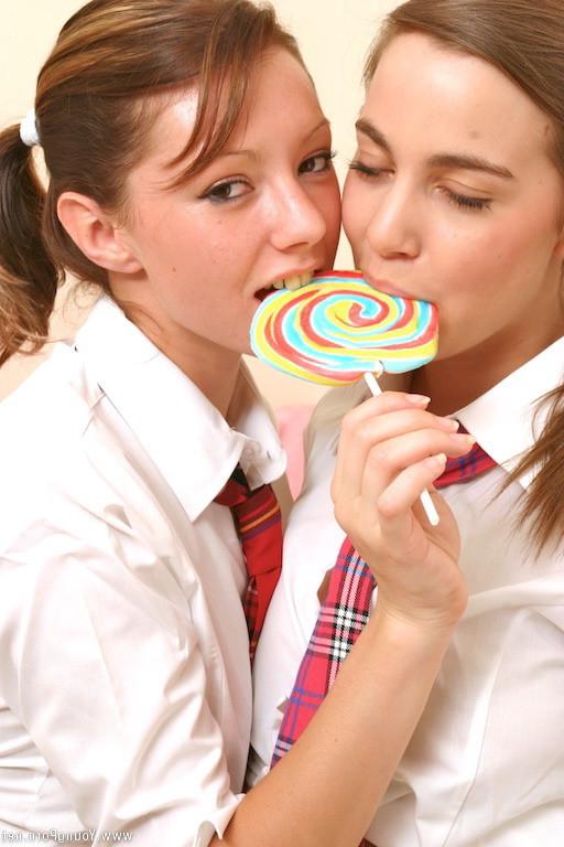 15P Cute school girls playing with lollipop and kissing