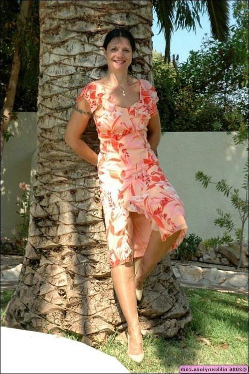 15P Mature Nikki in black stockings and heels outdoors