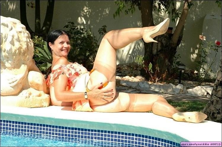 15P Mature Nikki in black stockings and heels outdoors