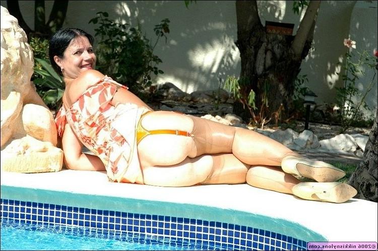 15P Mature Nikki in black stockings and heels outdoors