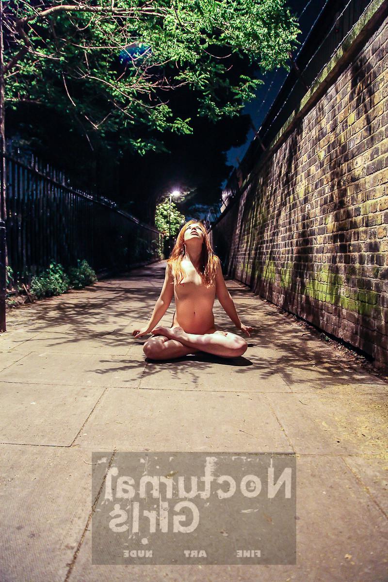 8P A girl is posing nude in the night time outdoor