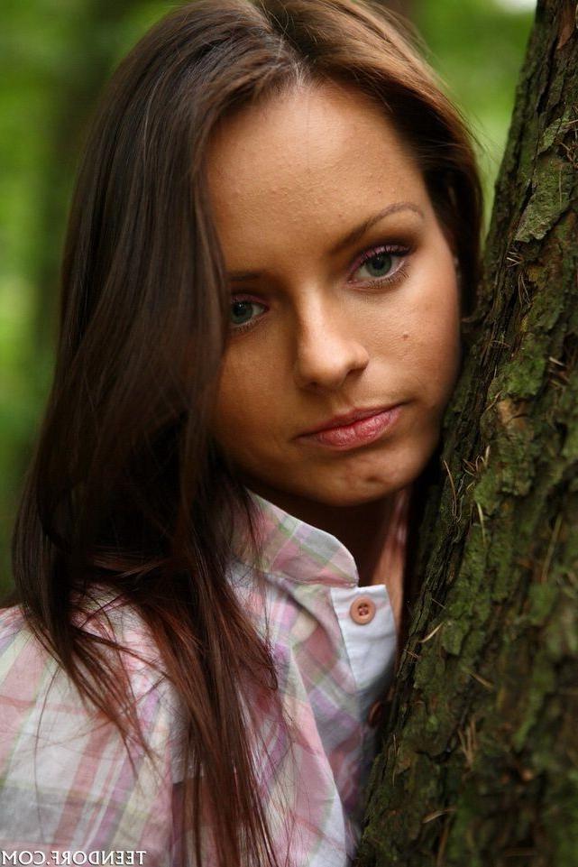 15P Brunette natural teen poses nude in a forest showing tits