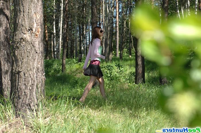 16P Cute babe pisses onto a fallen tree in the forest