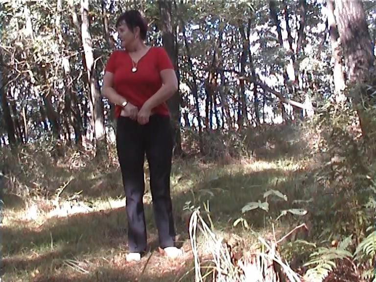25P A little Girl stands in the forest