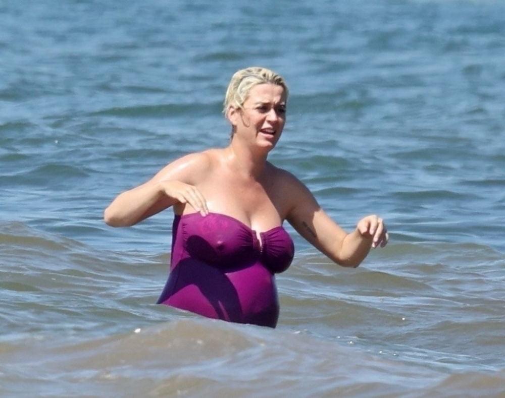 19P Pregnant Katy Perry in a purple swimsuit.