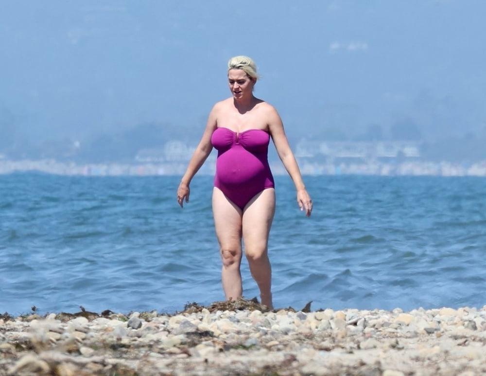19P Pregnant Katy Perry in a purple swimsuit.
