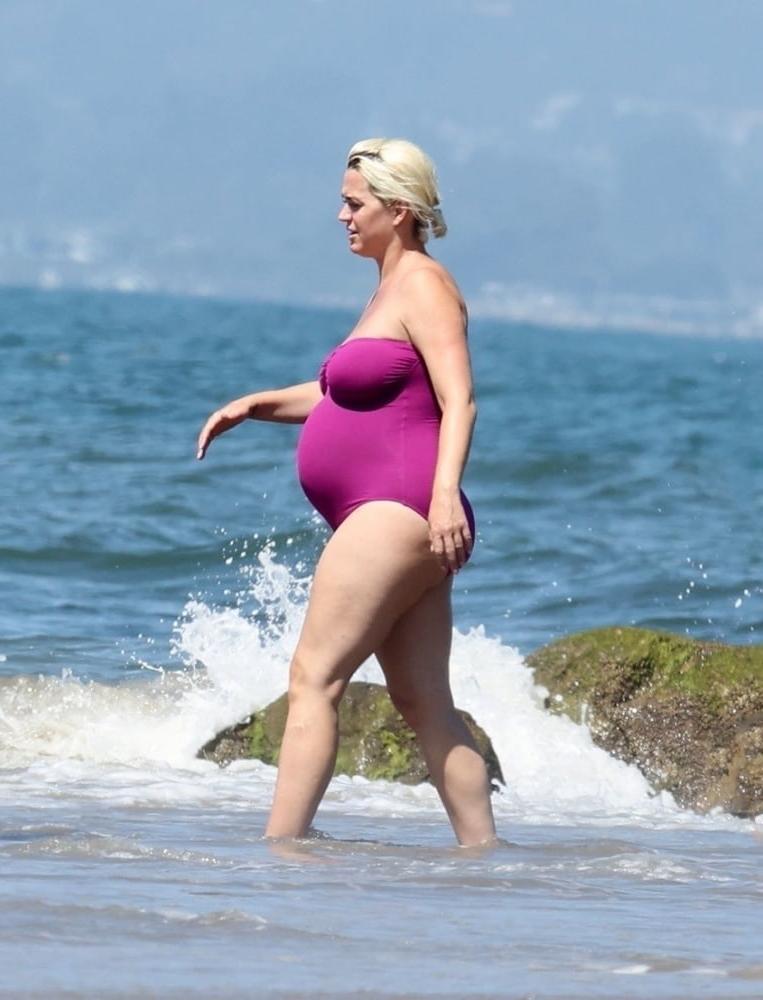 19P Pregnant Katy Perry in a purple swimsuit.
