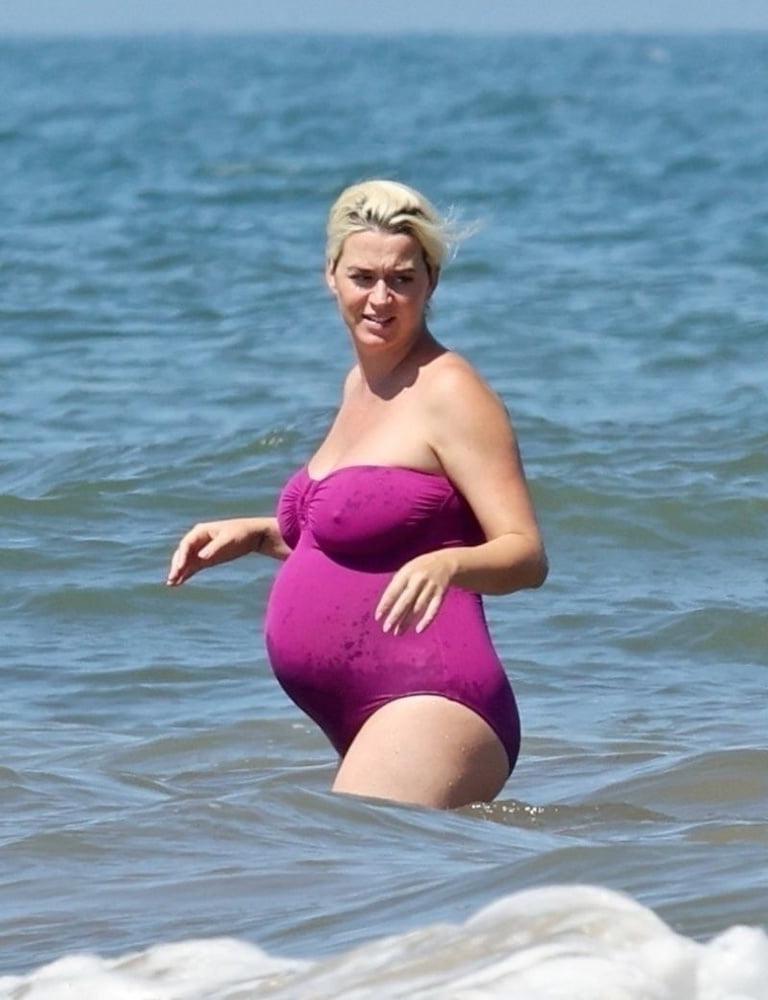 19P Pregnant Katy Perry in a purple swimsuit.