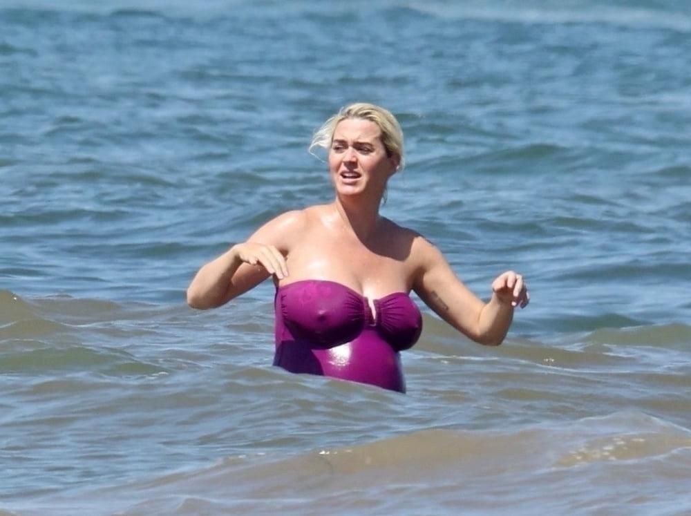 19P Pregnant Katy Perry in a purple swimsuit.