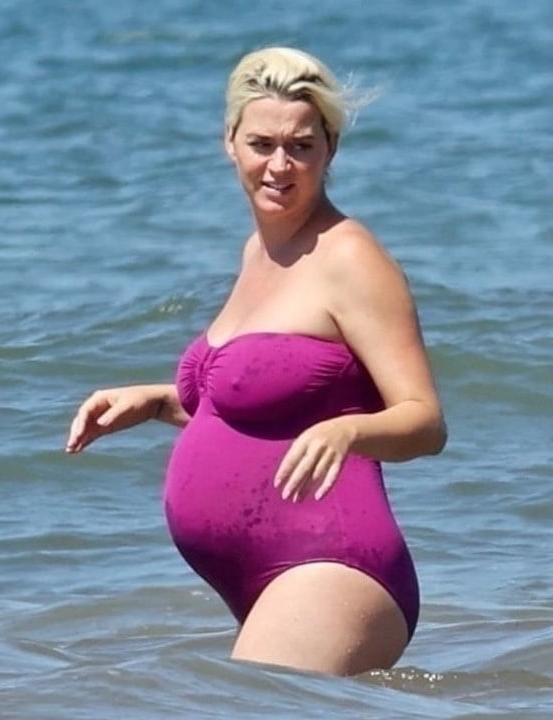 19P Katy Perry pregnant in a purple swimsuit