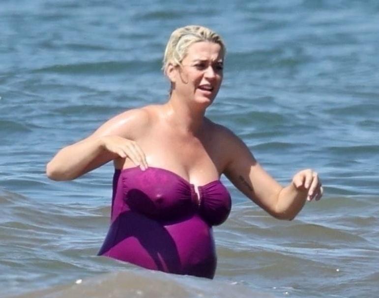 19P Katy Perry pregnant in a purple swimsuit