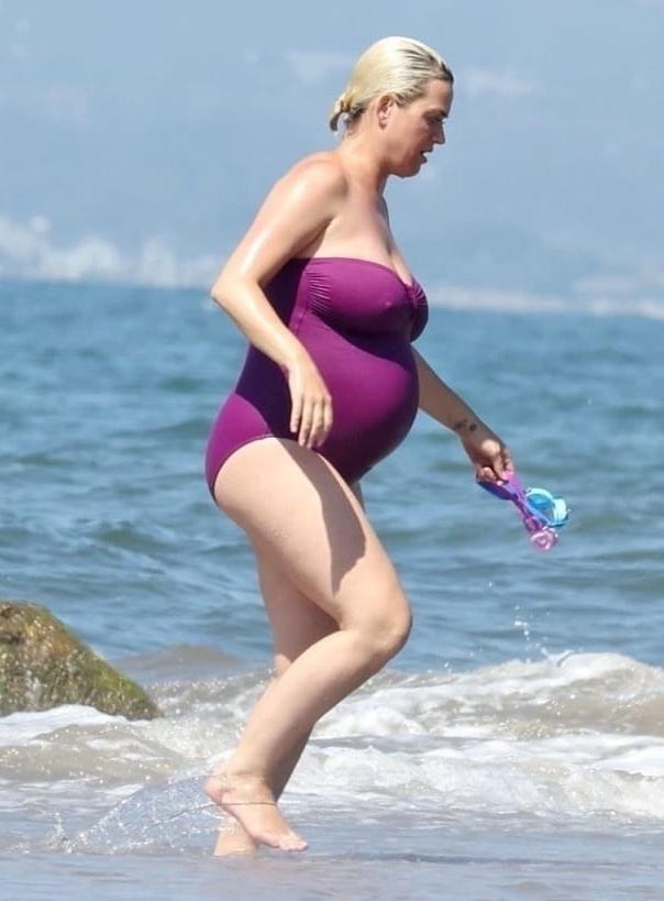 19P Katy Perry pregnant in a purple swimsuit