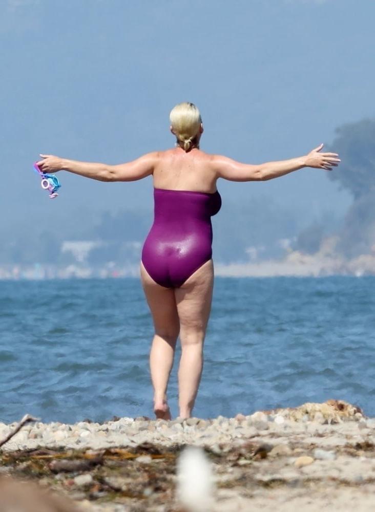 19P Katy Perry pregnant in a purple swimsuit