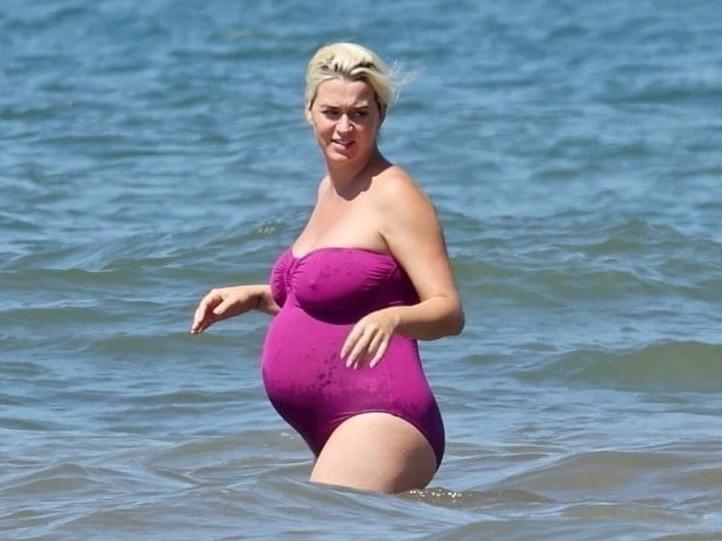 19P Katy Perry pregnant in a purple swimsuit