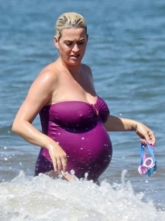 19P Katy Perry pregnant in a purple swimsuit