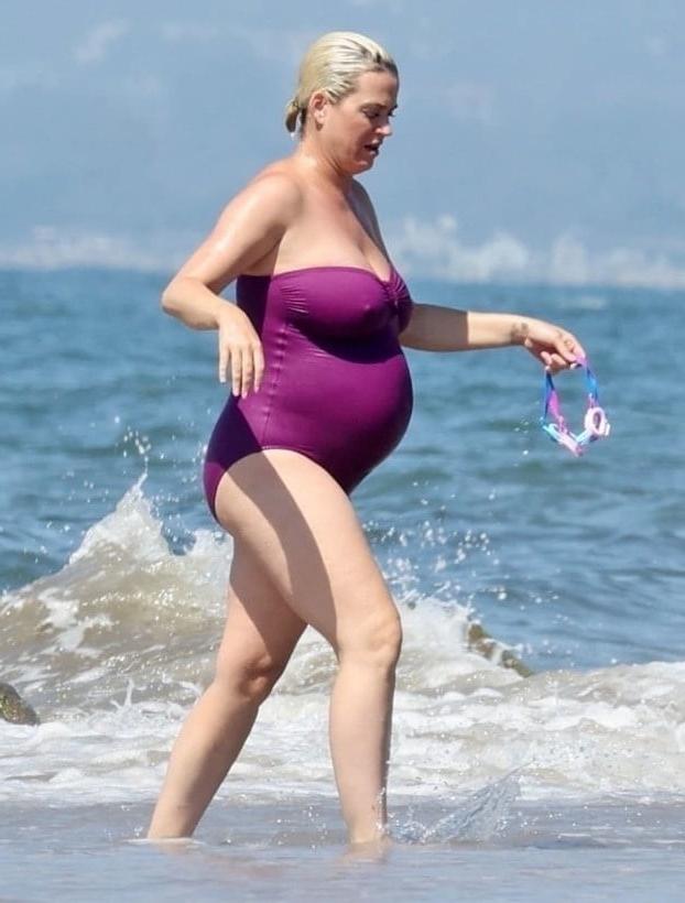 19P Katy Perry pregnant in a purple swimsuit