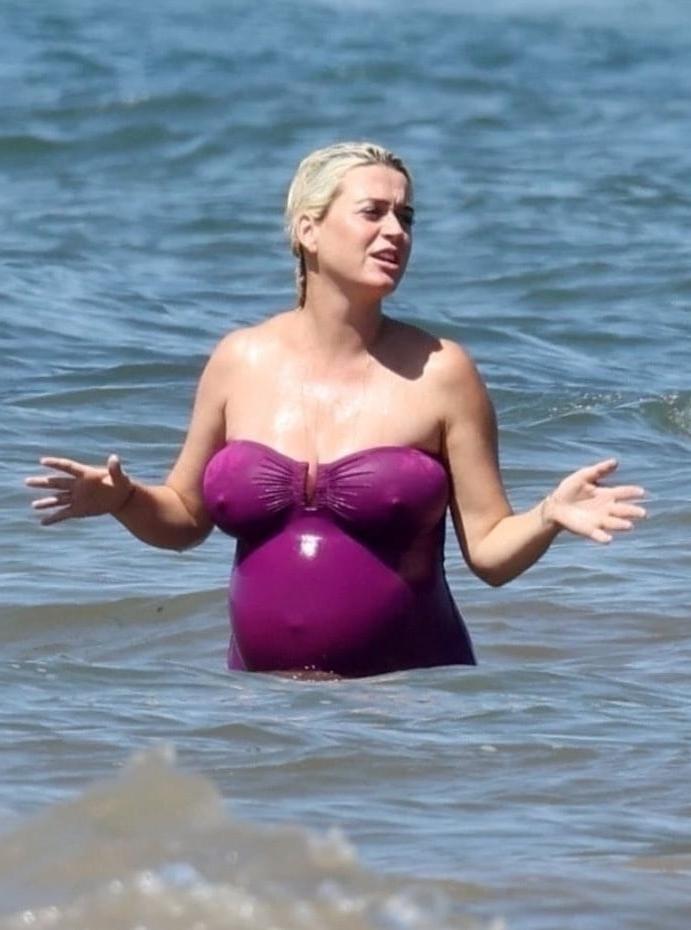19P Katy Perry pregnant in a purple swimsuit