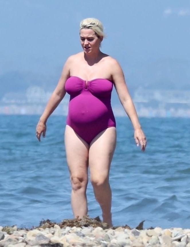 19P Katy Perry pregnant in a purple swimsuit