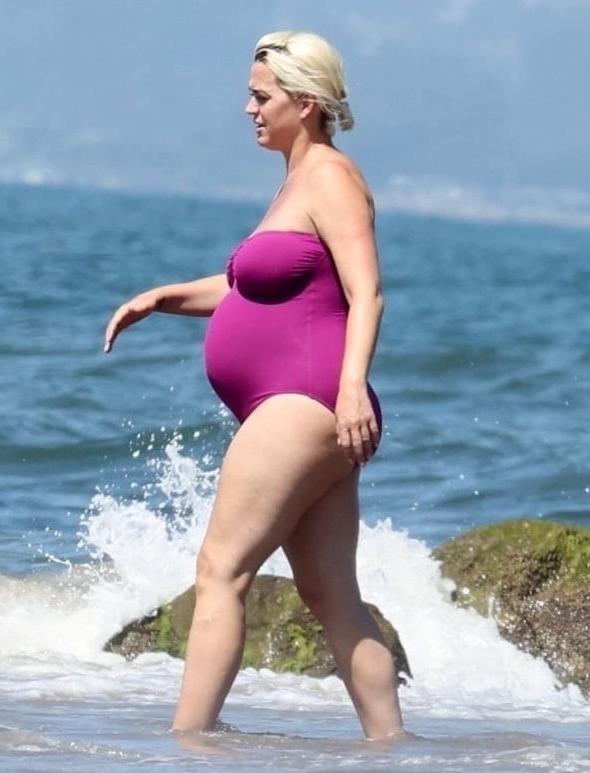 19P Katy Perry pregnant in a purple swimsuit