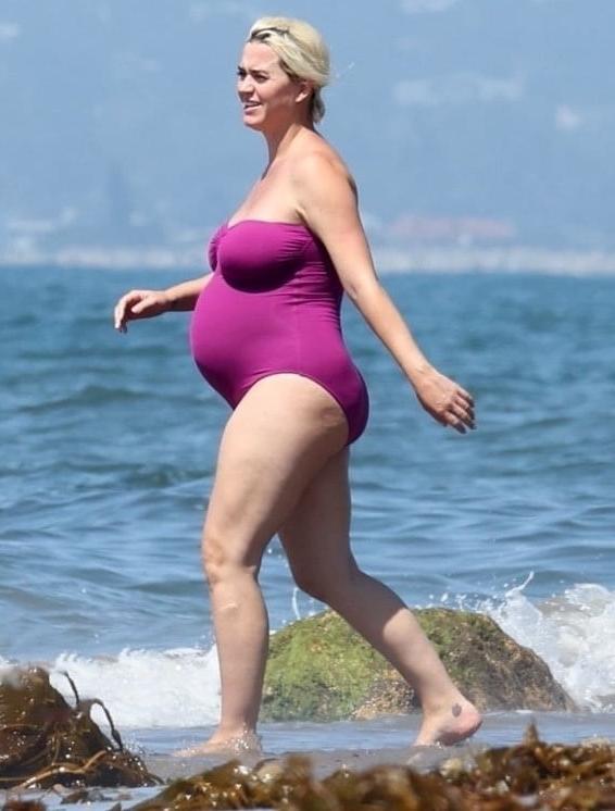 19P Katy Perry pregnant in a purple swimsuit