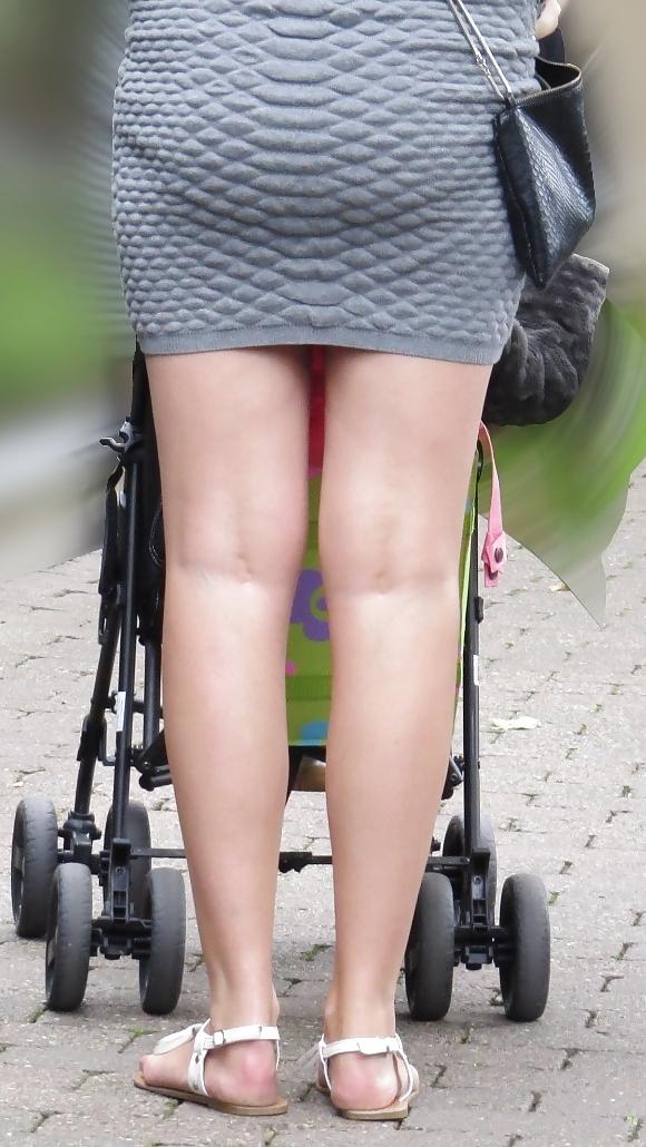 21P Sexy blonde in a very short skirt, reveals her long legs