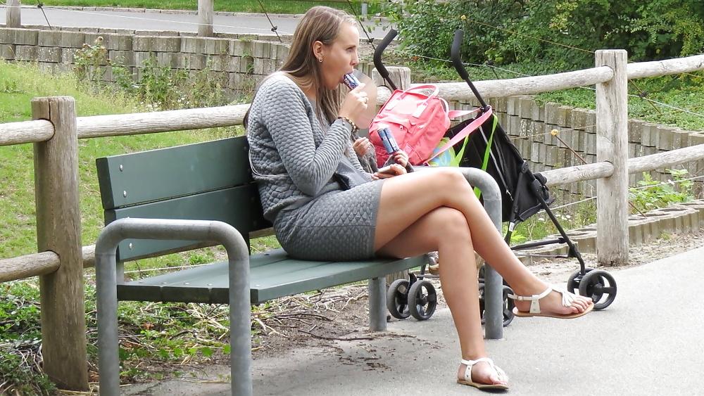 21P Sexy blonde in a very short skirt, reveals her long legs