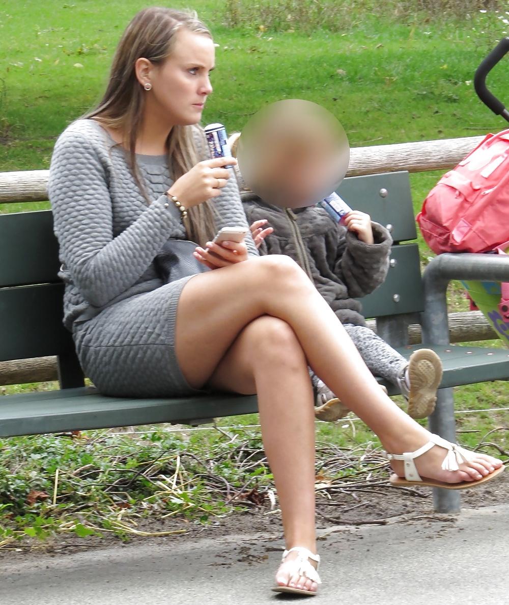 21P Sexy blonde in a very short skirt, reveals her long legs