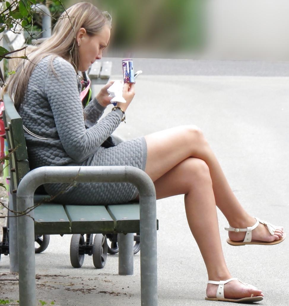 21P Sexy blonde in a very short skirt, reveals her long legs