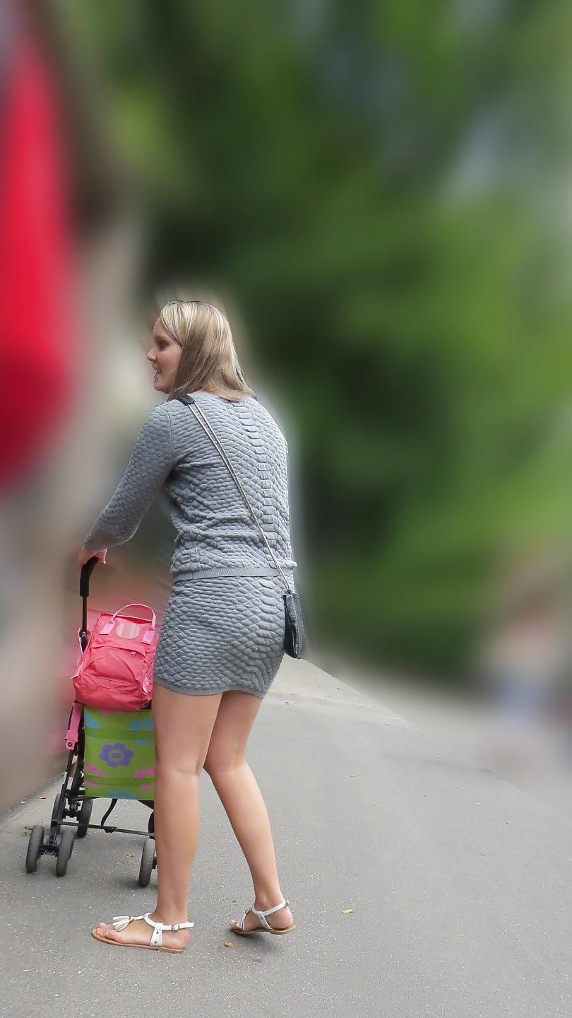 21P Sexy blonde in a very short skirt, reveals her long legs