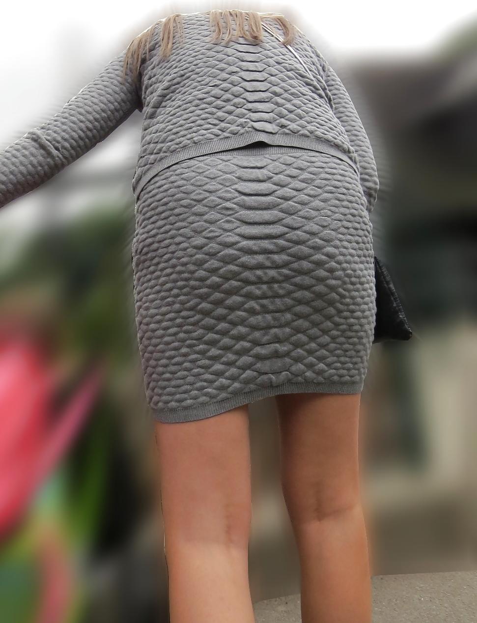 21P Sexy blonde in a very short skirt, reveals her long legs