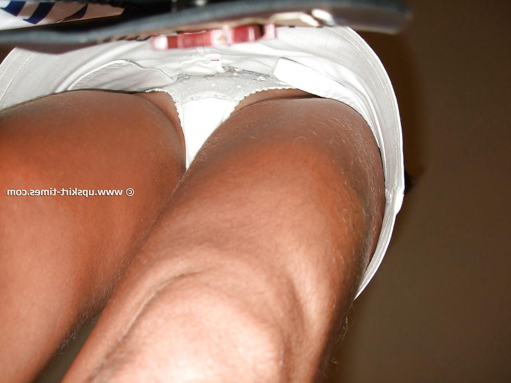 13P Slim tanned girl in a short white skirt