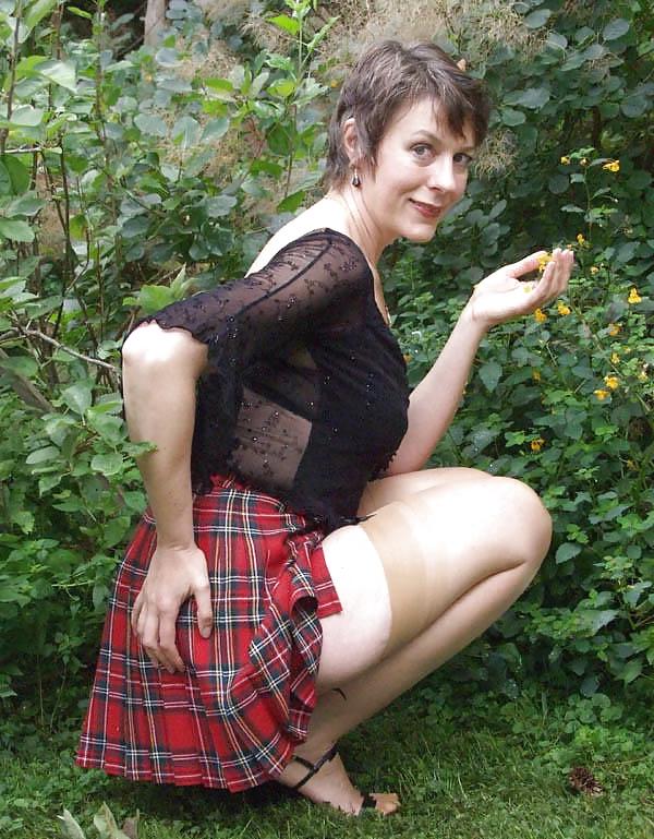 8P The lovely Miss Jones wears tartan skirt.