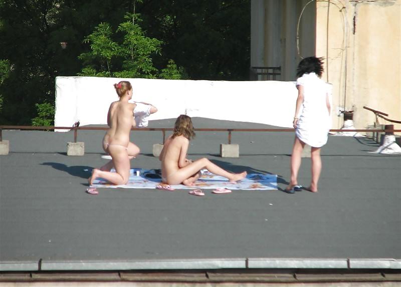 12P Three vouyered girls undressing and sunbathing in the roof.