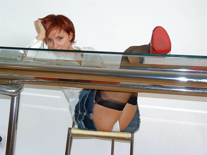 17P Kelly Dee in black nylon stockings flashing under the desk
