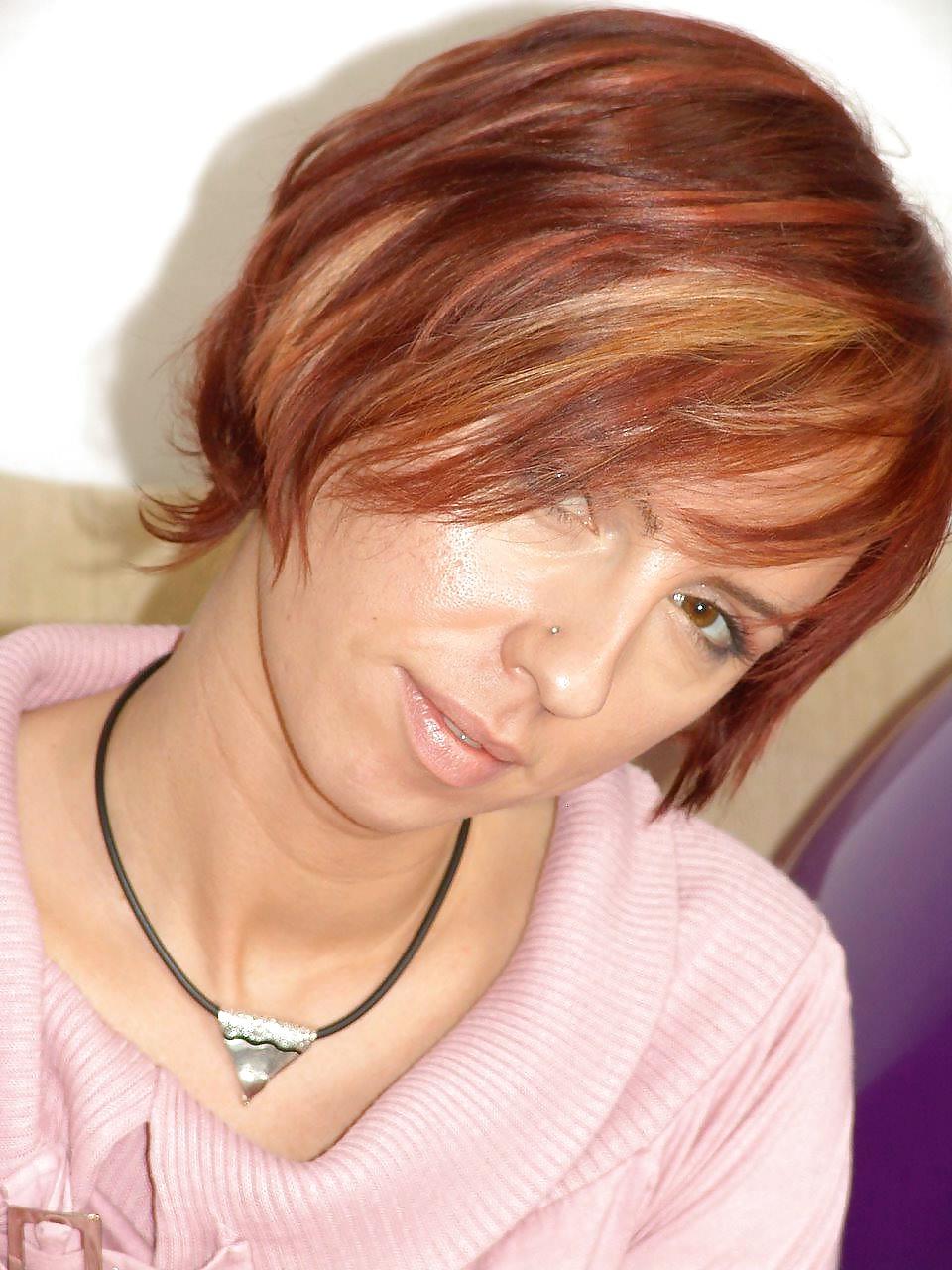 25P Kelly Dee in white stockings playing on the sofa